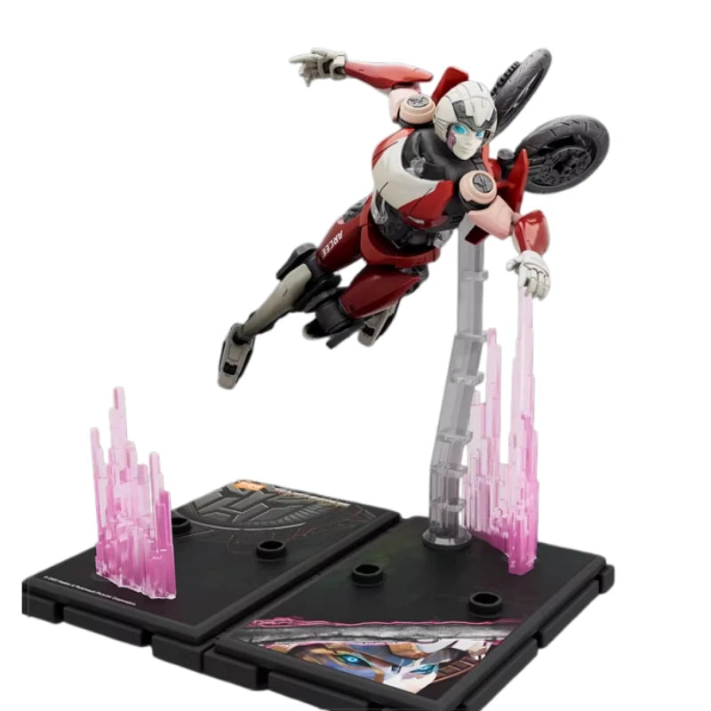 Figura Transformers Arcee Vuelo Acrobático — Robot Rosa y Gris Base Luminosa
