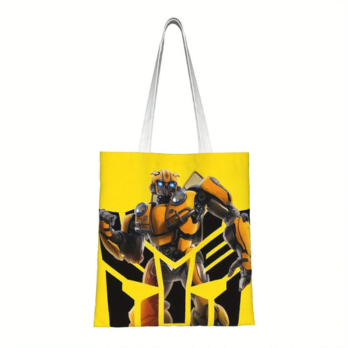 Sac tote bag jaune avec le robot Bumblebee en posture dynamique et fond noir stylisé – Transformers.