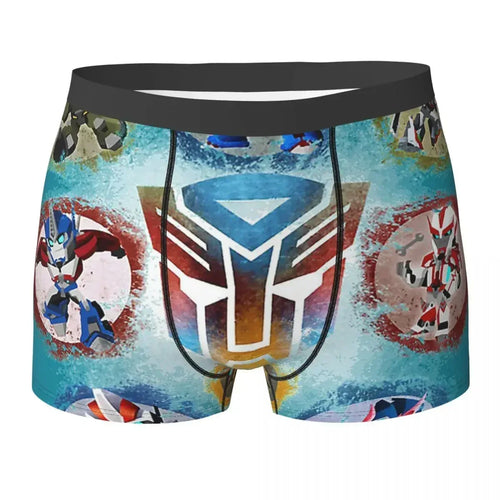 Boxer enfant bleu décoré de robots colorés et logo central stylisé, fond effet spray – Transformers.