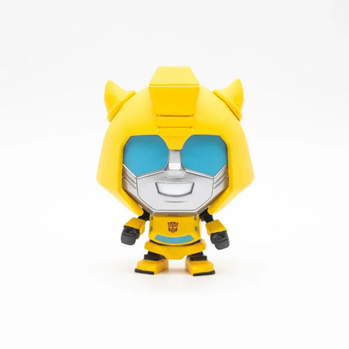 Figurine vinyl Bumblebee jaune et argent souriant, style cartoon sur fond blanc – Transformers.