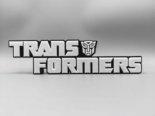 Placa Transformers Logo Plateado Monocromático — Decoración de Escritorio Edición Metalizada