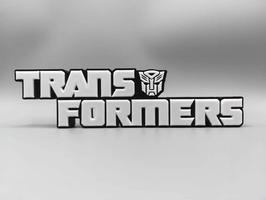 Placa Transformers Logo Plateado Monocromático — Decoración de Escritorio Edición Metalizada