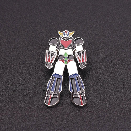 Pin émaillé robot géant coloré en métal, personnage debout sur fond noir – Transformers.