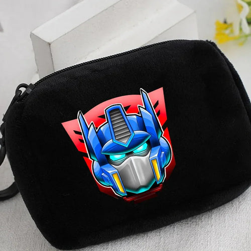 Trousse noire décorée du visage bleu d’un robot stylisé sur fond rouge vif – Transformers.